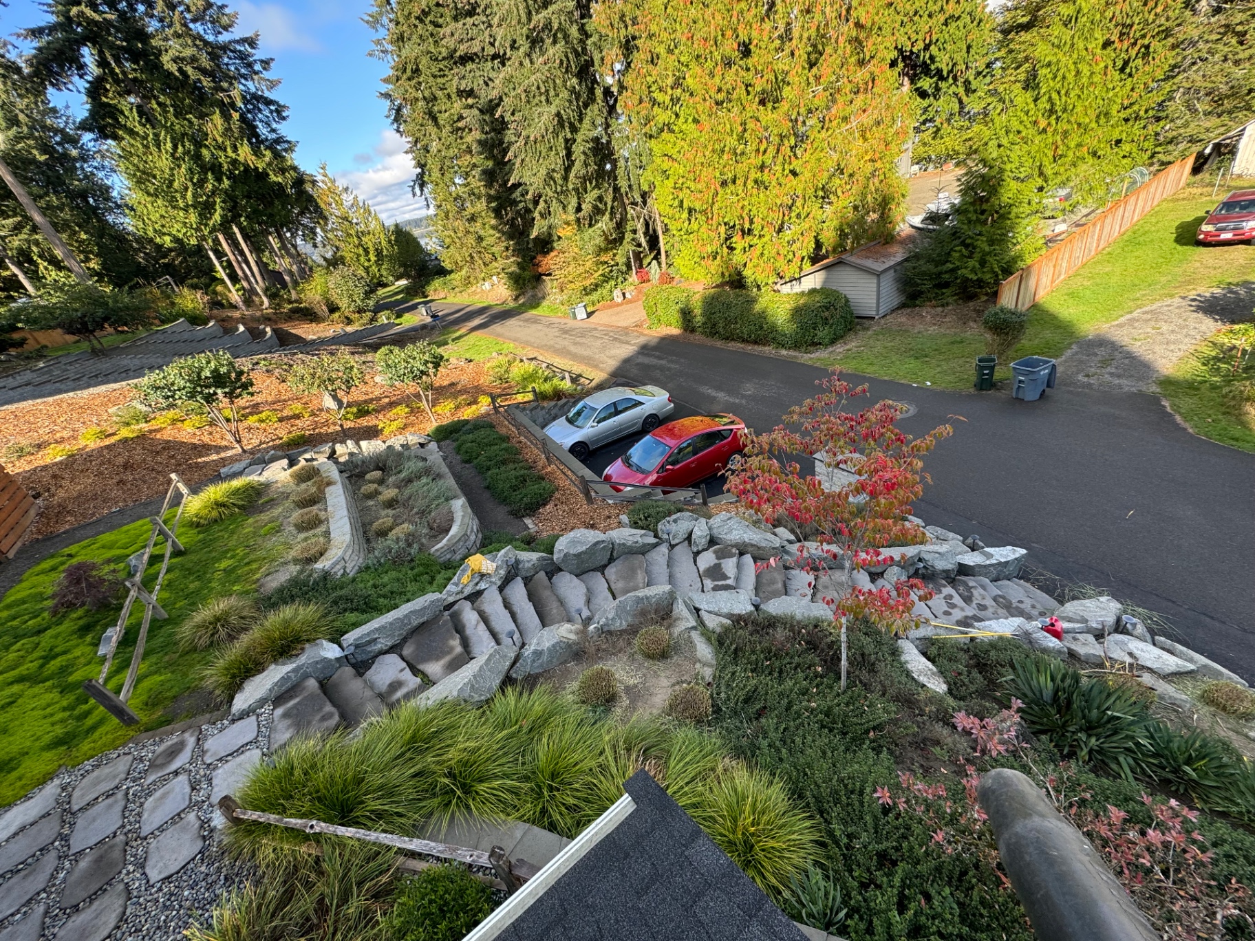 Hillside garden installation with stone steps and terraced beds