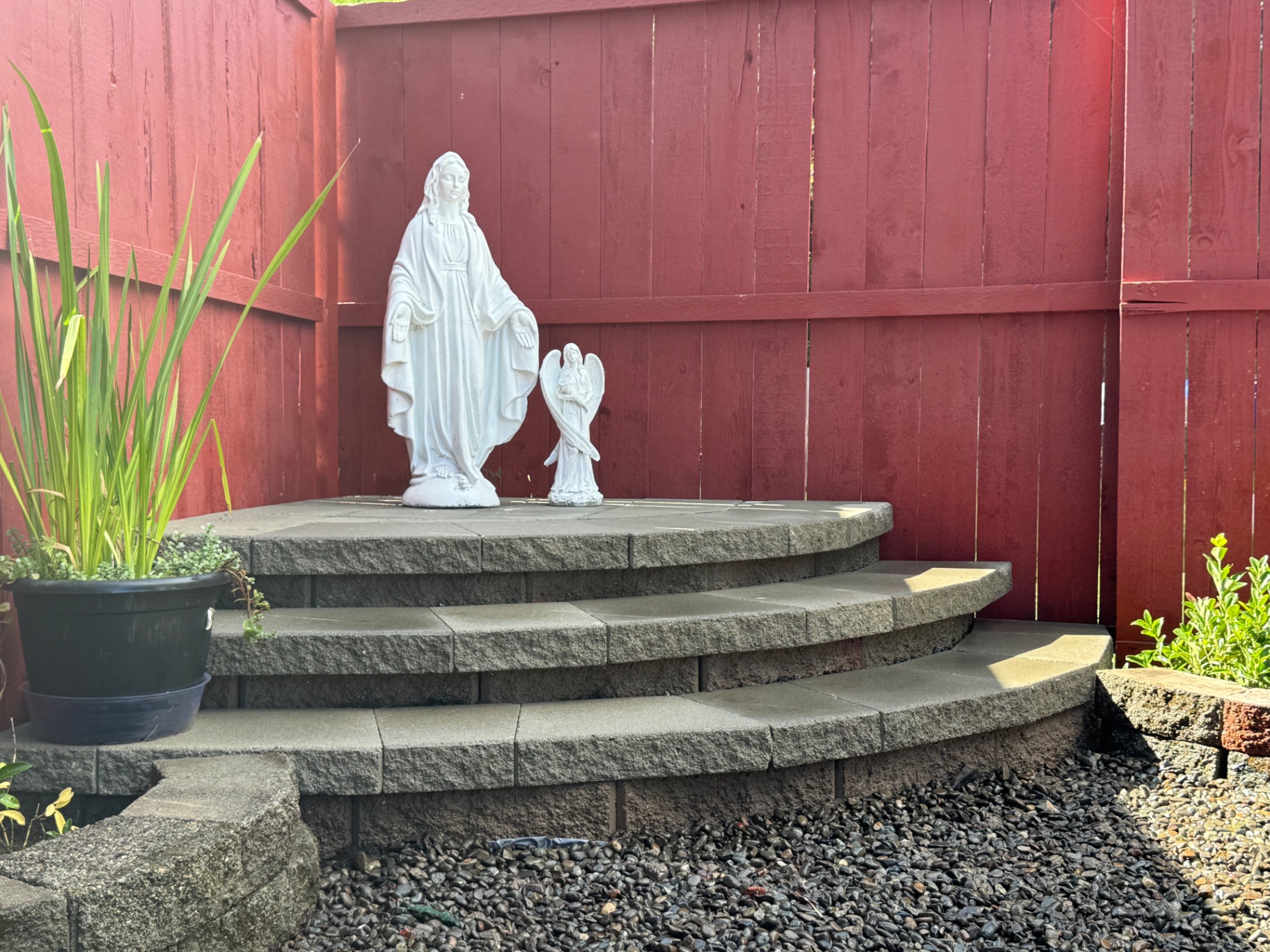 Paver garden shrine with curved steps and planter