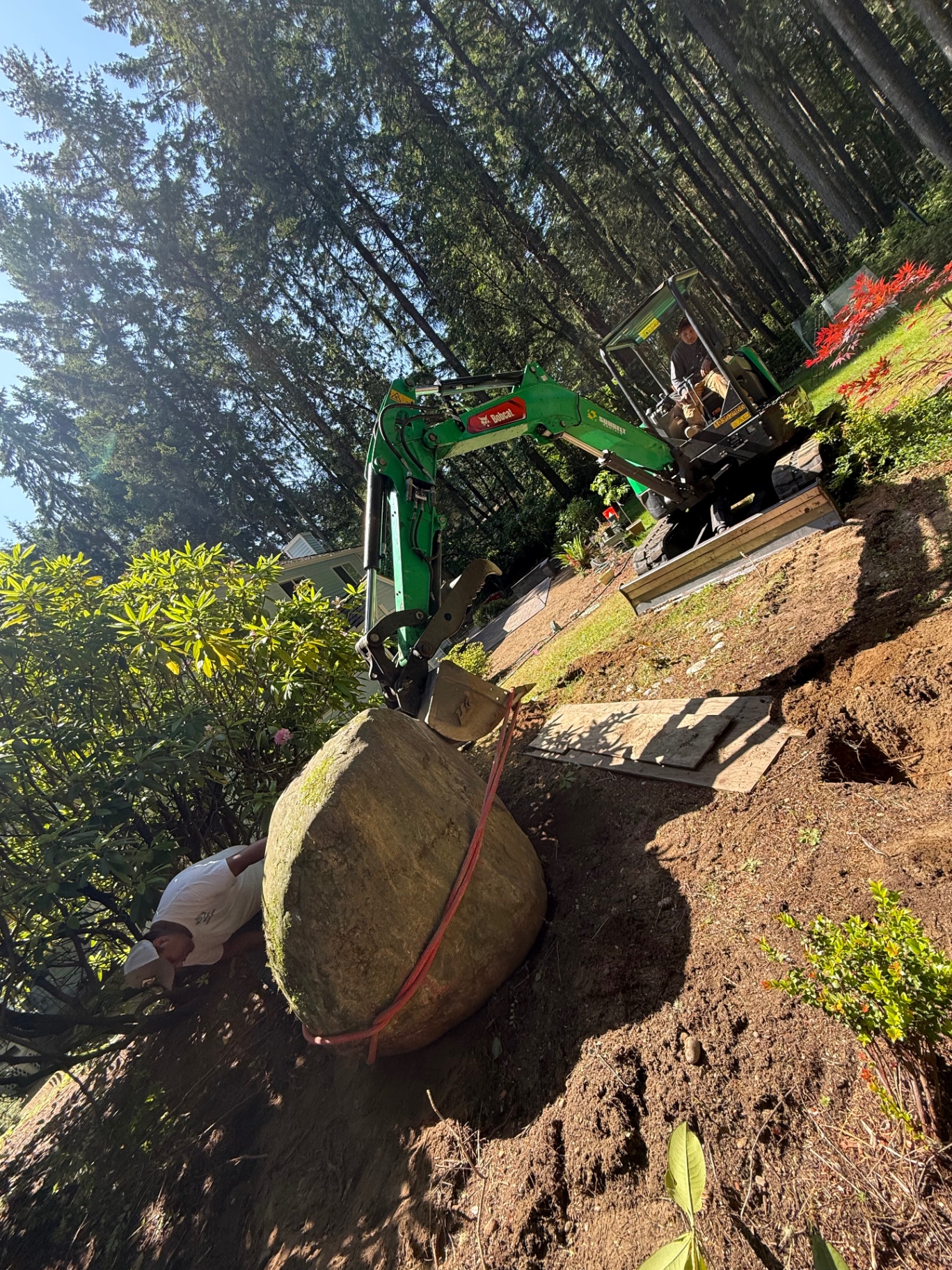 Large boulder placement with mini excavator for garden hardscape