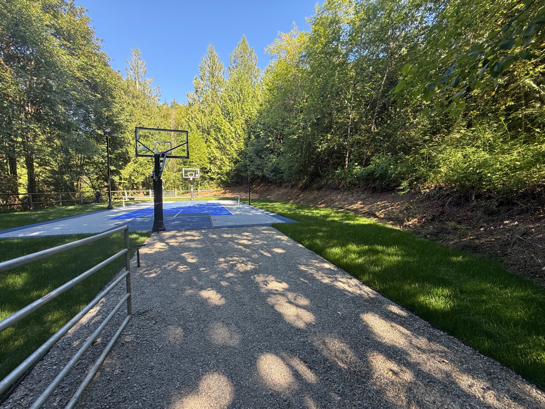 Backyard sport court install with fresh sod and gravel access path