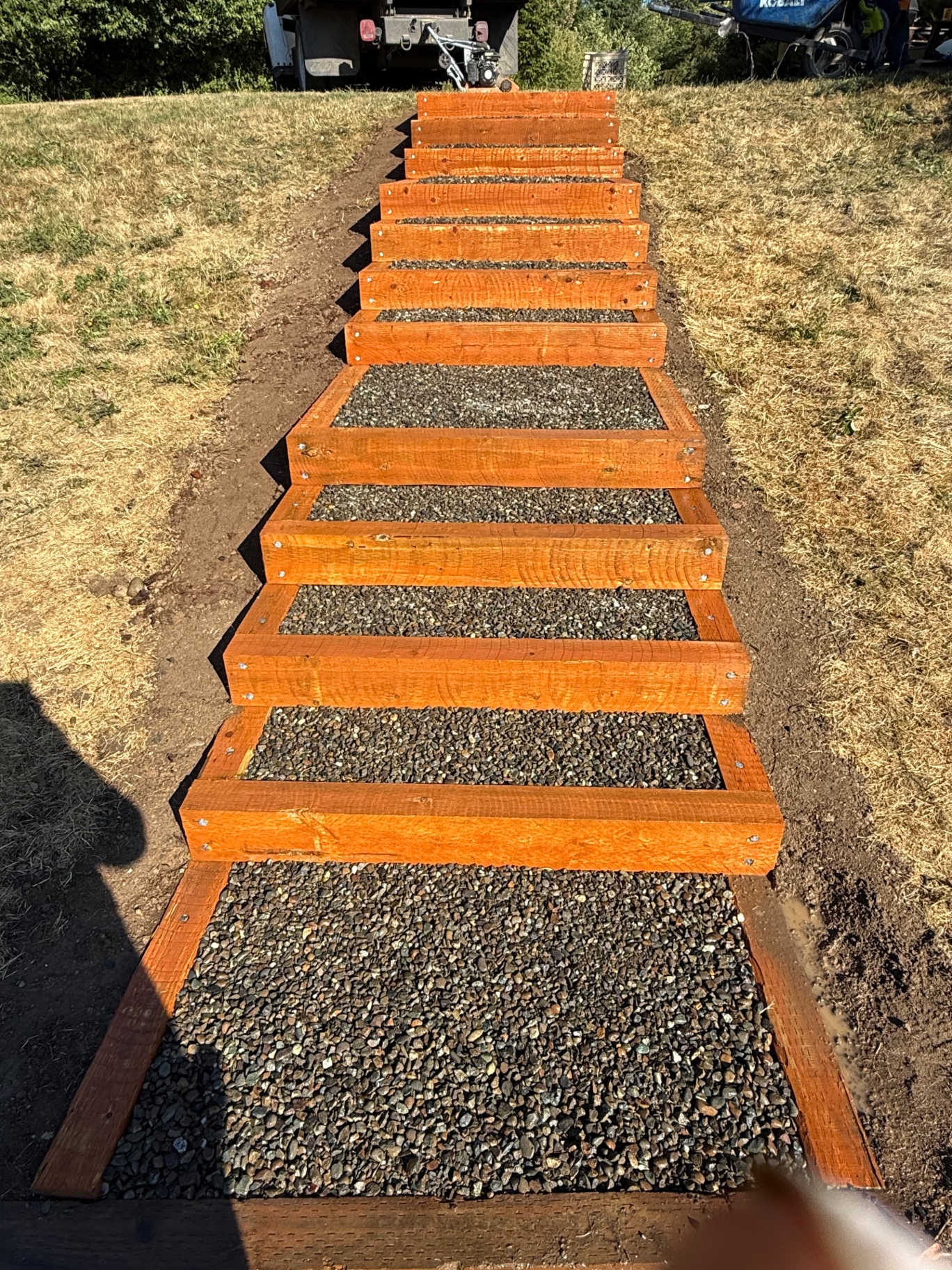Custom wood-and-gravel step pathway on a slope